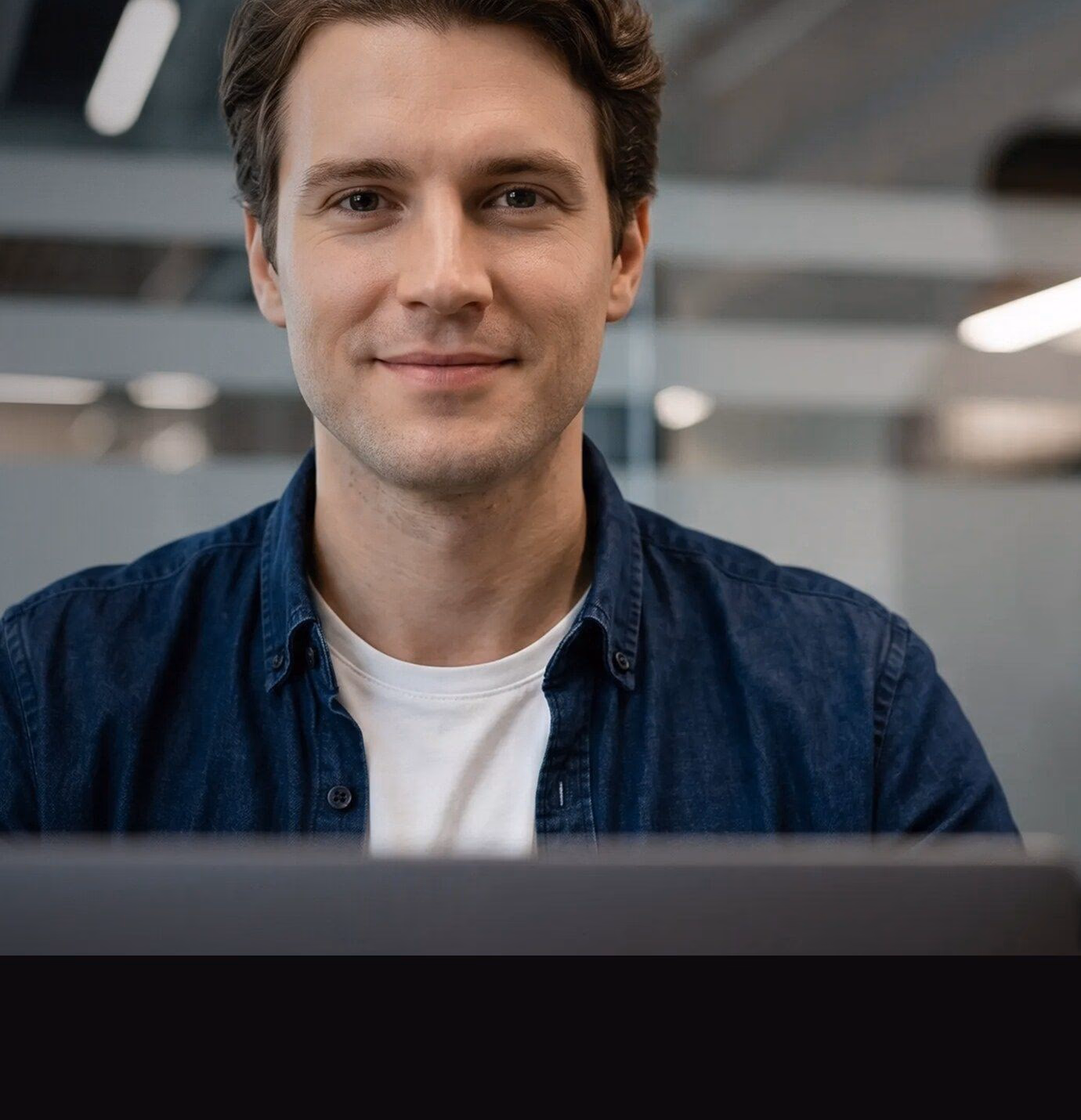 IT professional smiling in a modern data center office