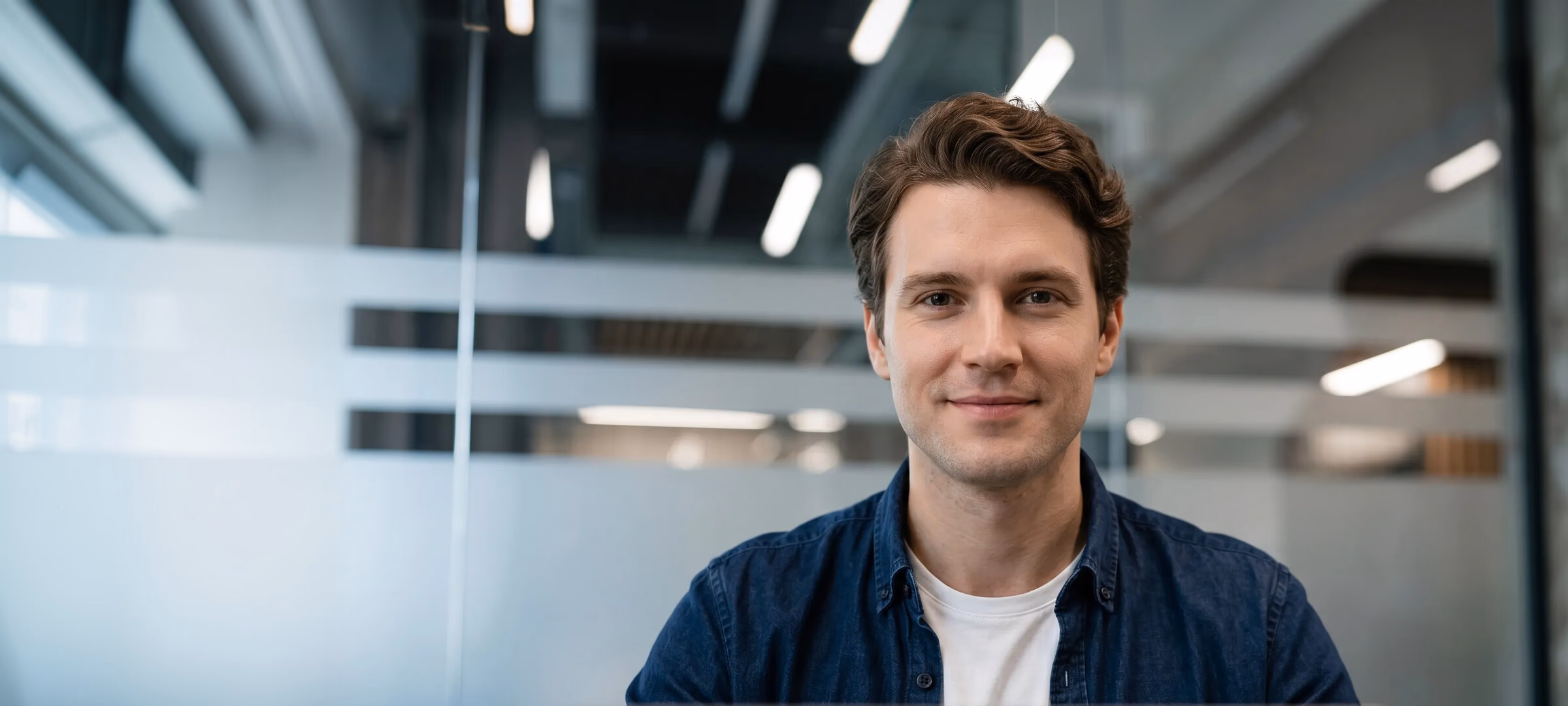 IT professional smiling in a modern data center office